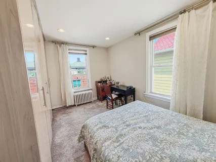 a bed room with a bed and a window
