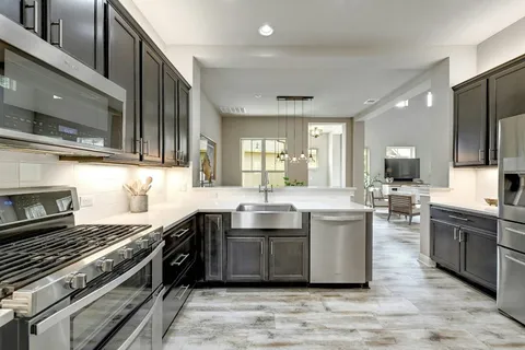 a large kitchen with stainless steel appliances