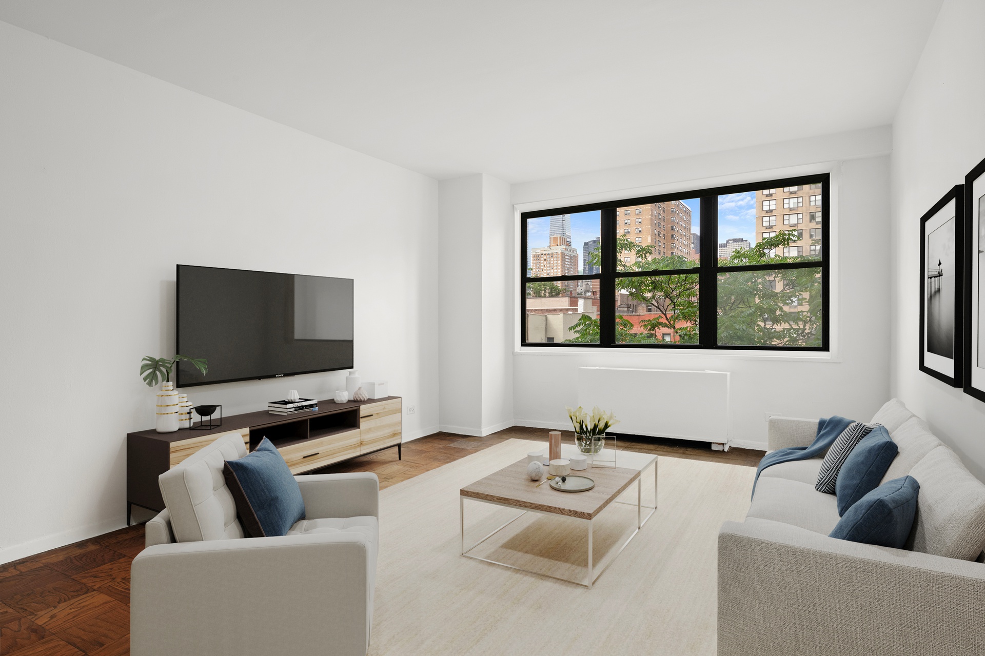 245 East 25th Street, Unit 8K Manhattan, NY 10010 - Photo 2 of 7 a living room with furniture and a flat screen tv