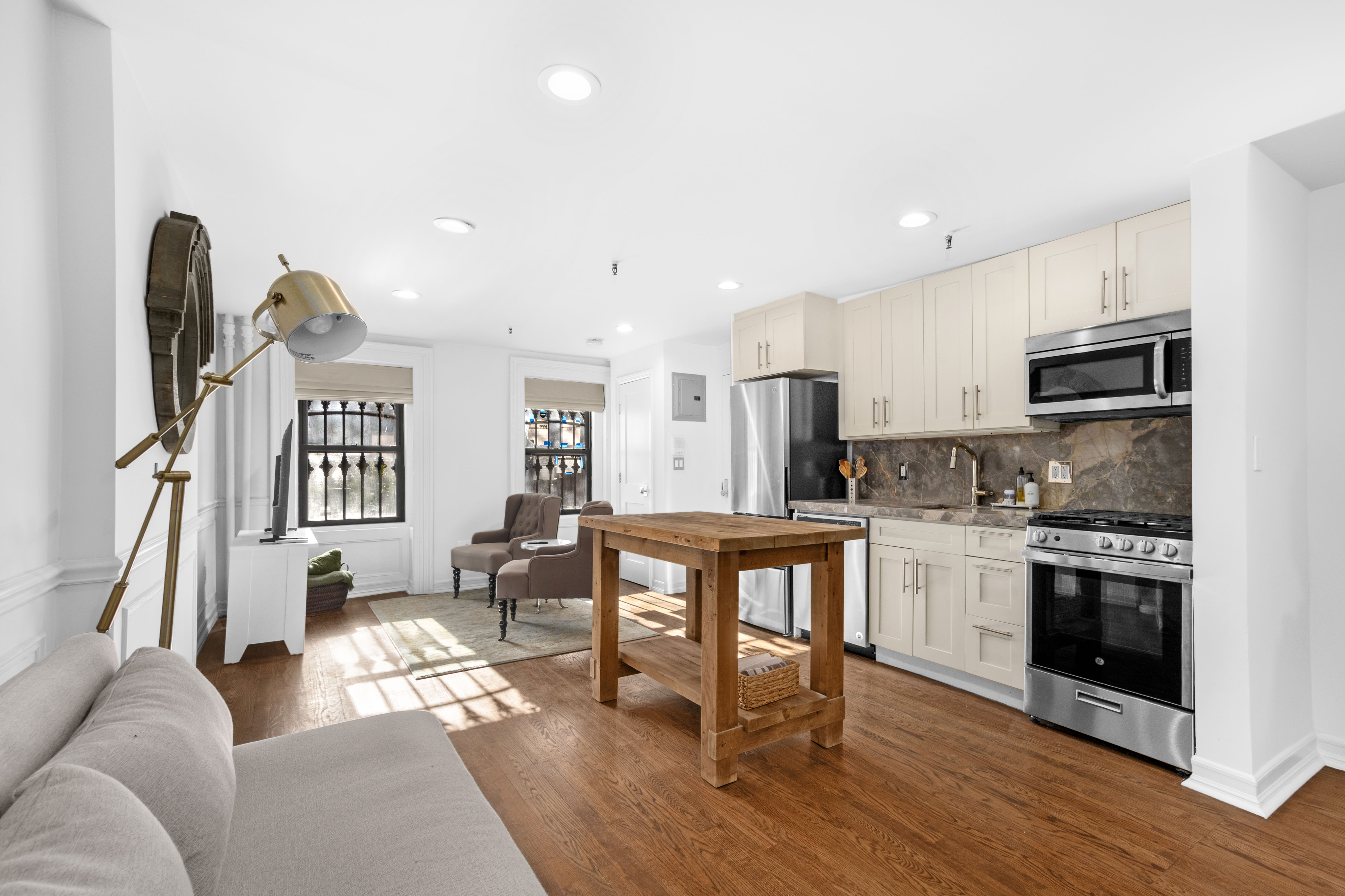 191 MacDonough Street, Unit 2 Brooklyn, NY 11216 - Photo 1 of 7 a living room with stainless steel appliances furniture and a kitchen view