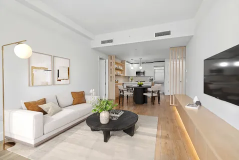 a living room with furniture and a dining table with kitchen view