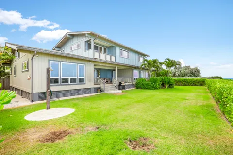 a view of a house with backyard porch and sitting area