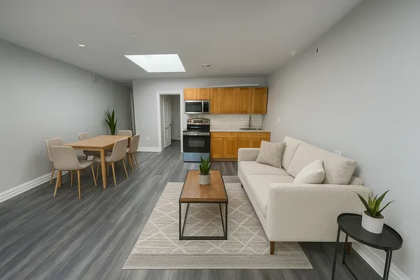 a living room with furniture and wooden floor