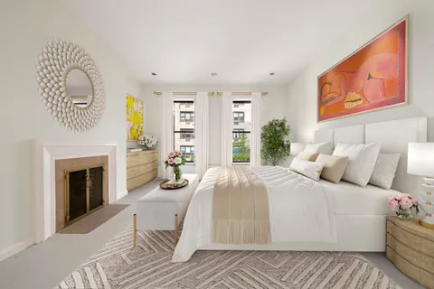 a bedroom with a bed and a fireplace