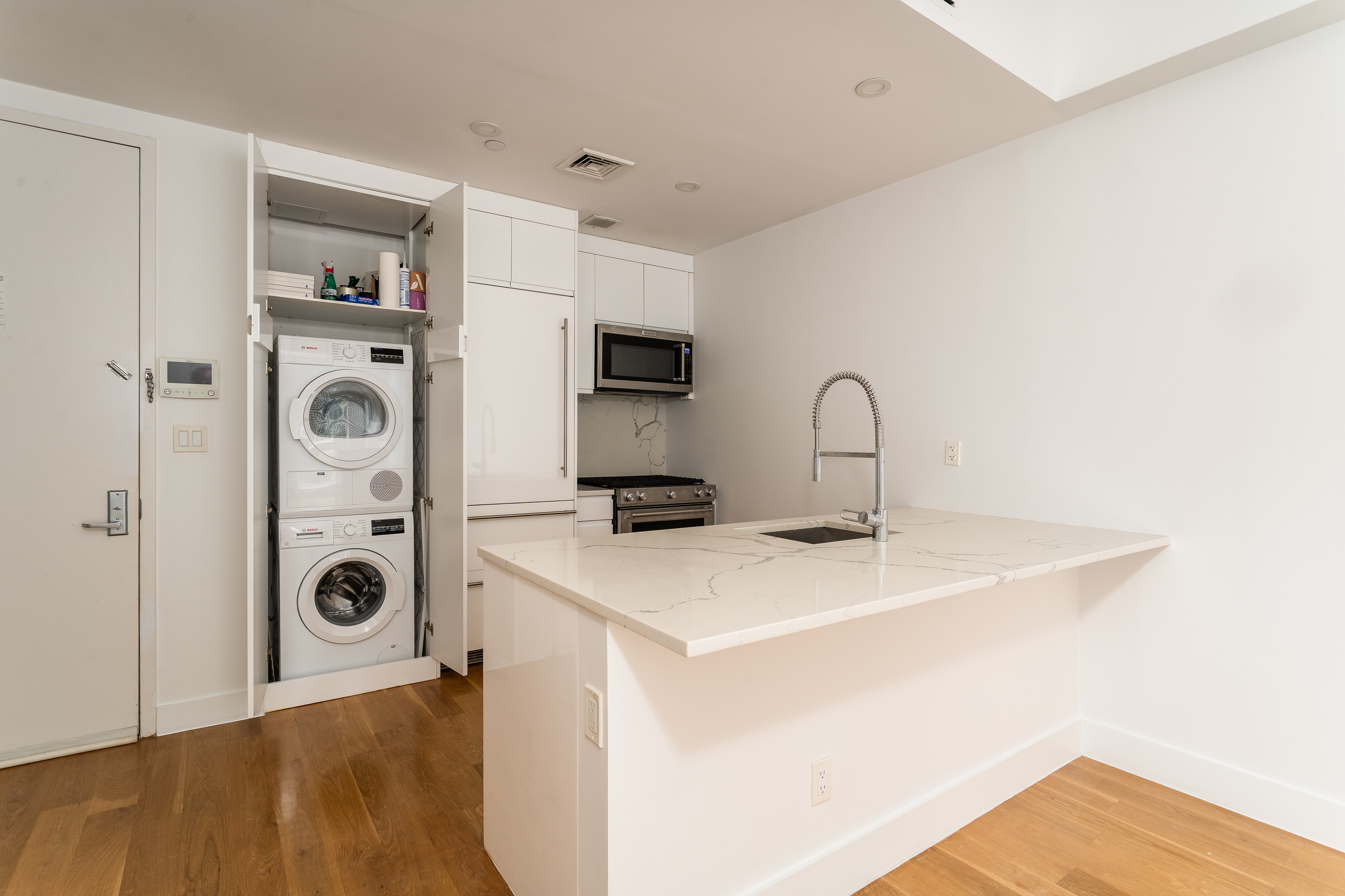21 Powers Street, Unit 3A Brooklyn, NY 11211 - Photo 11 of 14 a view of a kitchen with a sink and a microwave