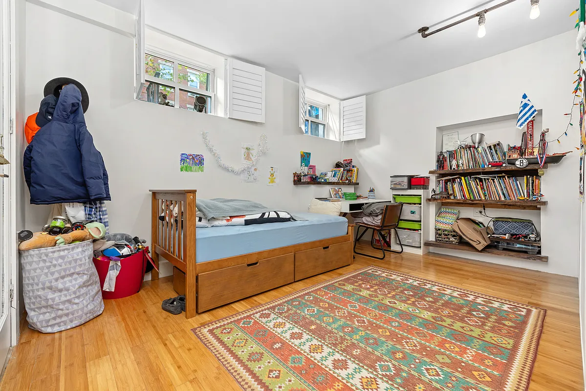 155 Luquer Street, Unit 1 Brooklyn, NY 11231 - Photo 10 of 13 a bedroom with furniture and a wooden floor