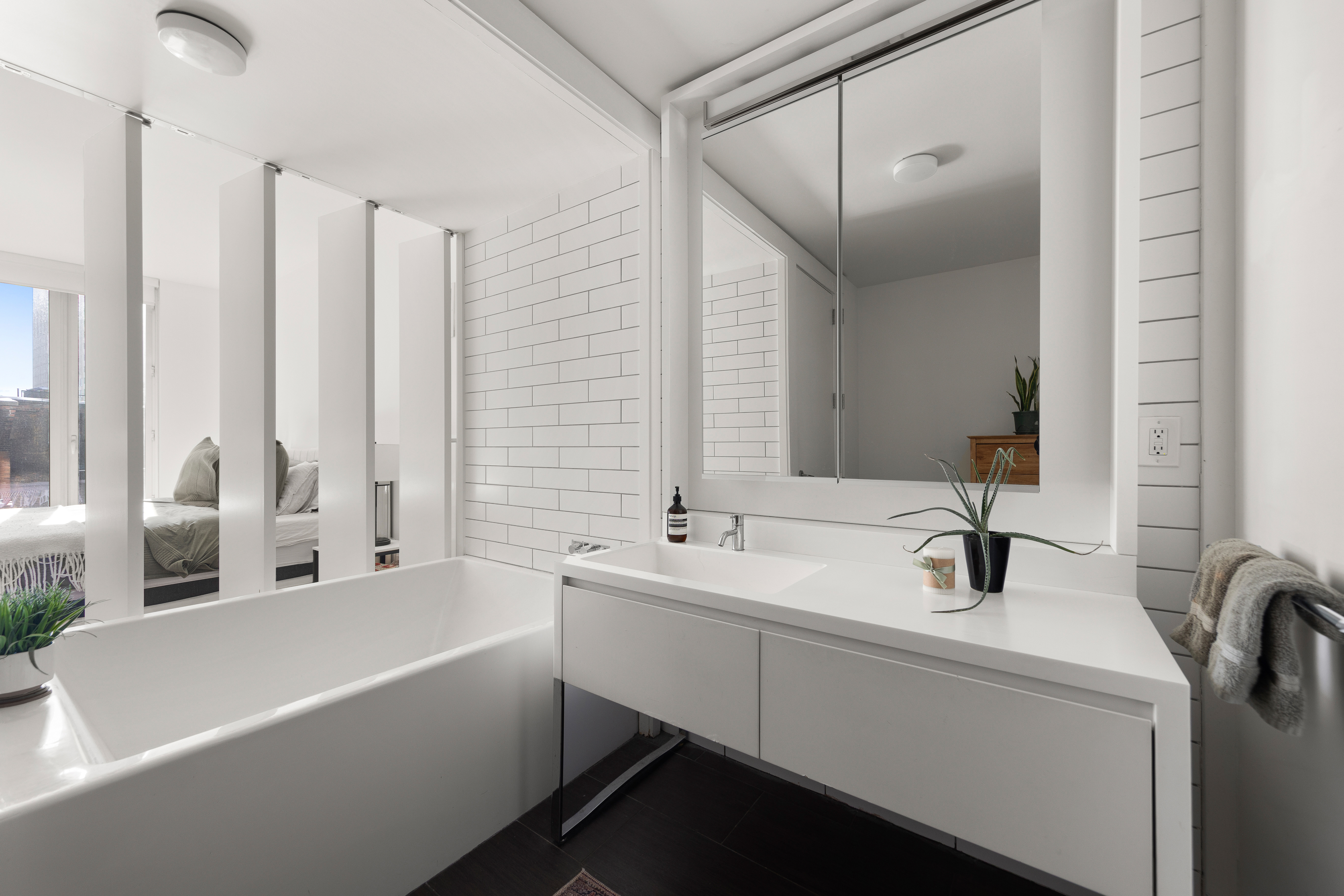 15 William Street, Unit 10C Manhattan, NY 10005 - Photo 7 of 15 a bathroom with a sink and a bathtub
