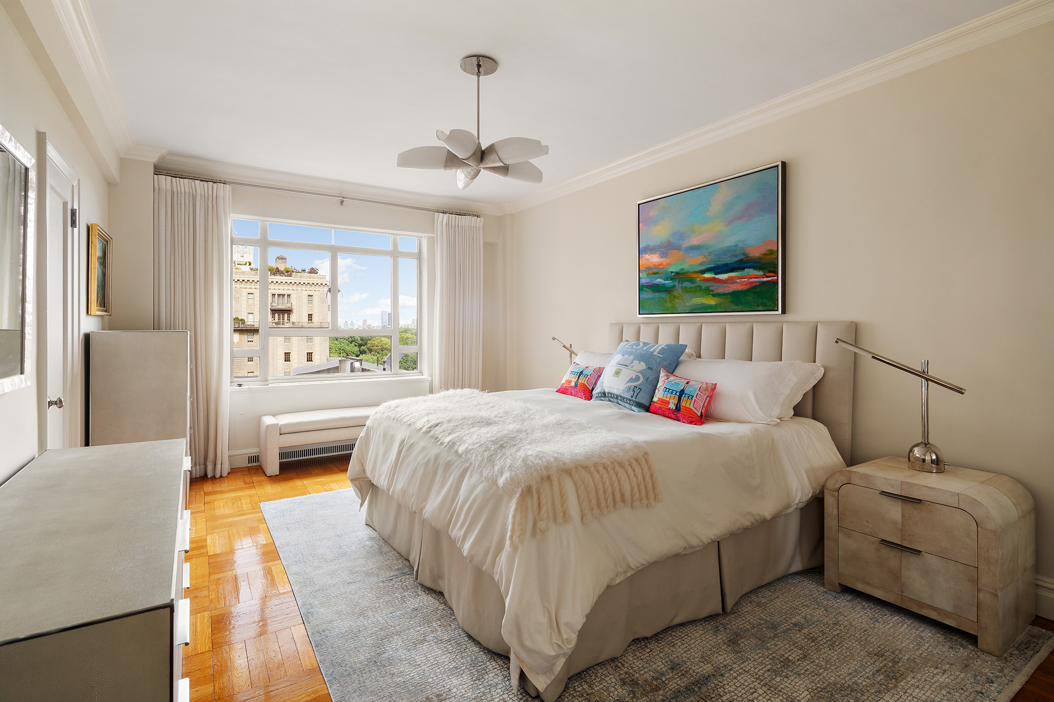 25 Central Park West, Unit 14R Manhattan, NY 10023 - Photo 4 of 22 a bedroom with a bed and a chandelier