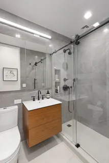 a bathroom with a sink mirror toilet and bathtub