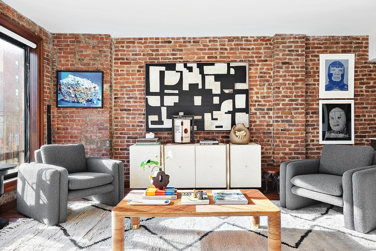 115 Allen Street, Unit 3 Manhattan, NY 10002 - Photo 12 of 13 a living room with furniture and a fireplace