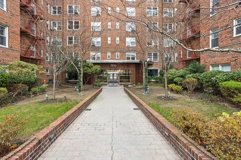 a view of a building with a yard