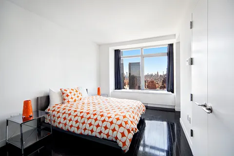 a bedroom with a bed and a large window