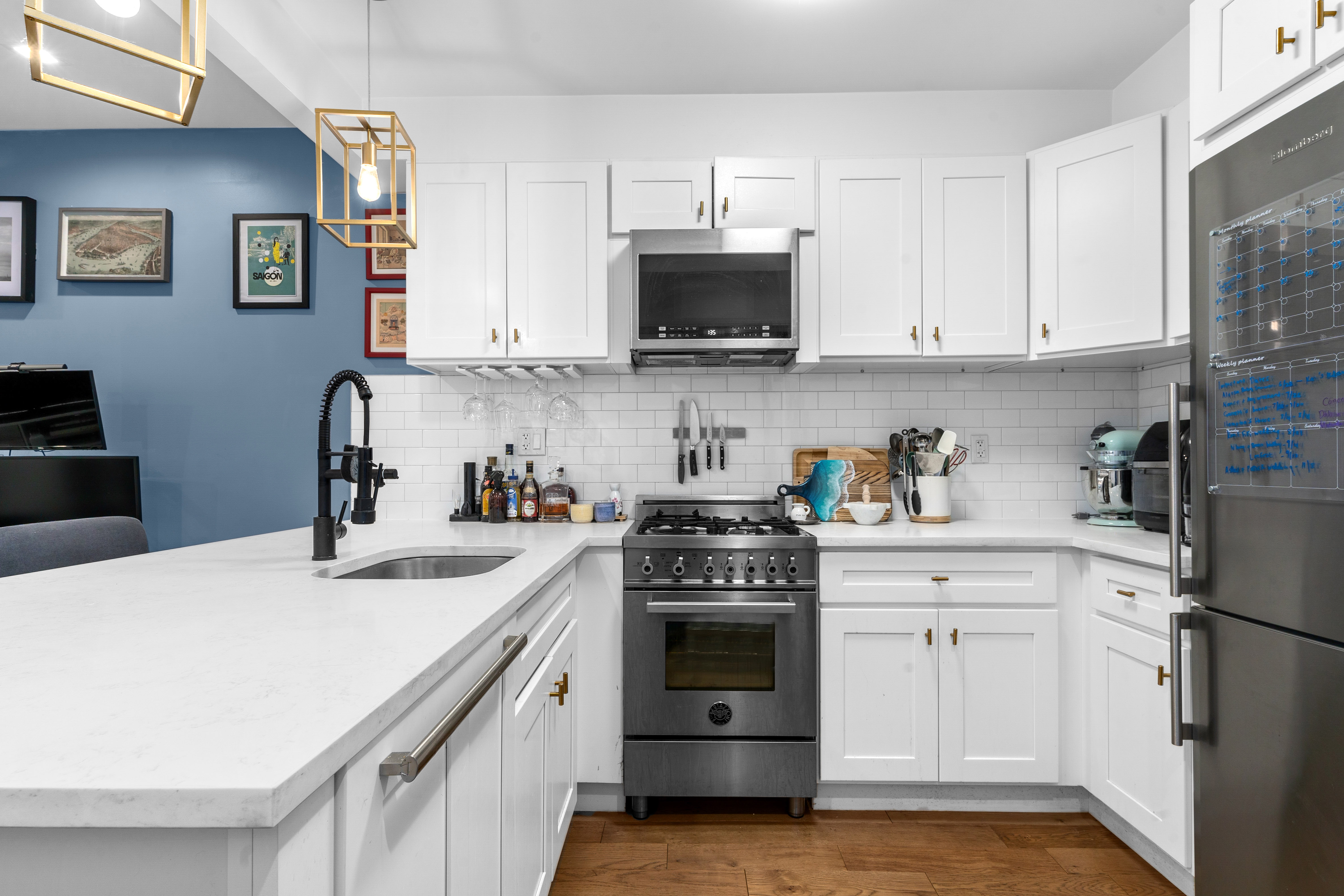 1229 Putnam Avenue, Unit 2A Brooklyn, NY 11221 - Photo 4 of 10 a kitchen with white cabinets and stainless steel appliances