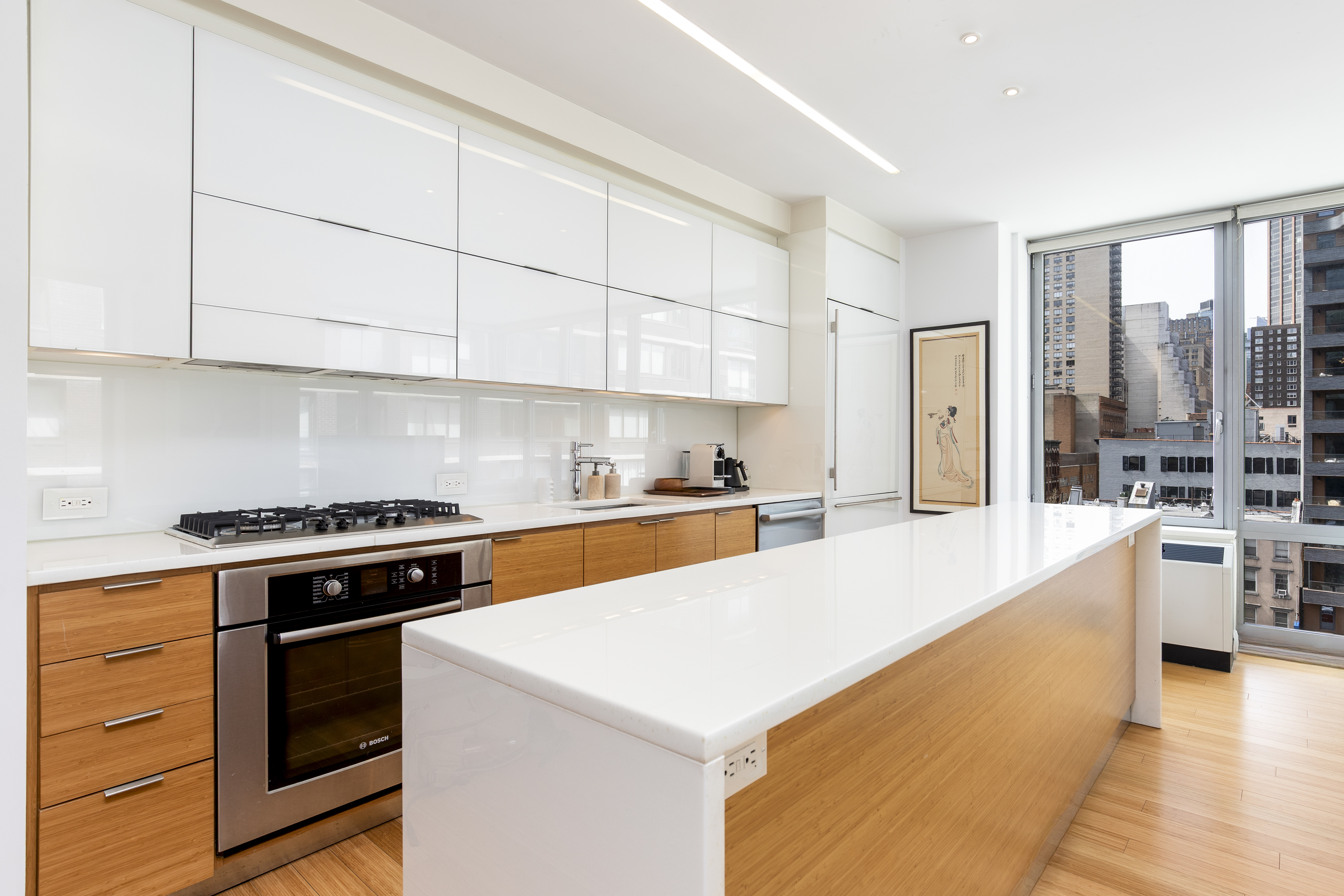 a kitchen with stainless steel appliances a stove a sink and a refrigerator