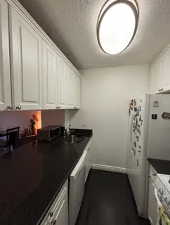 a stove top oven sitting inside of a kitchen