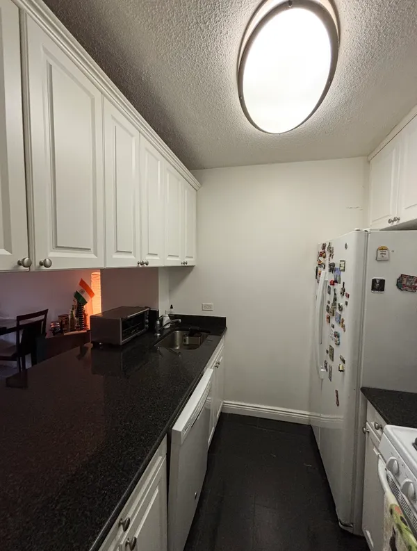 a stove top oven sitting inside of a kitchen