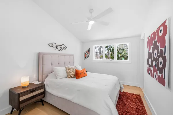 a bedroom with a bed and wooden floor