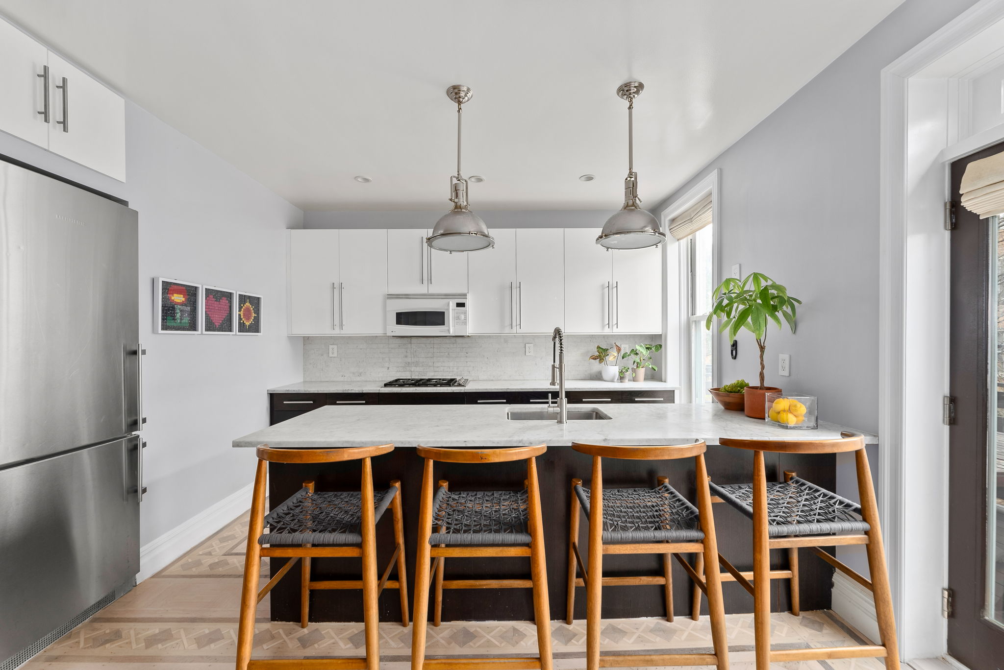 6 Virginia Place Brooklyn, NY 11213 - Photo 6 of 26 a kitchen with stainless steel appliances granite countertop a stove a refrigerator white cabinets a dining table and chairs