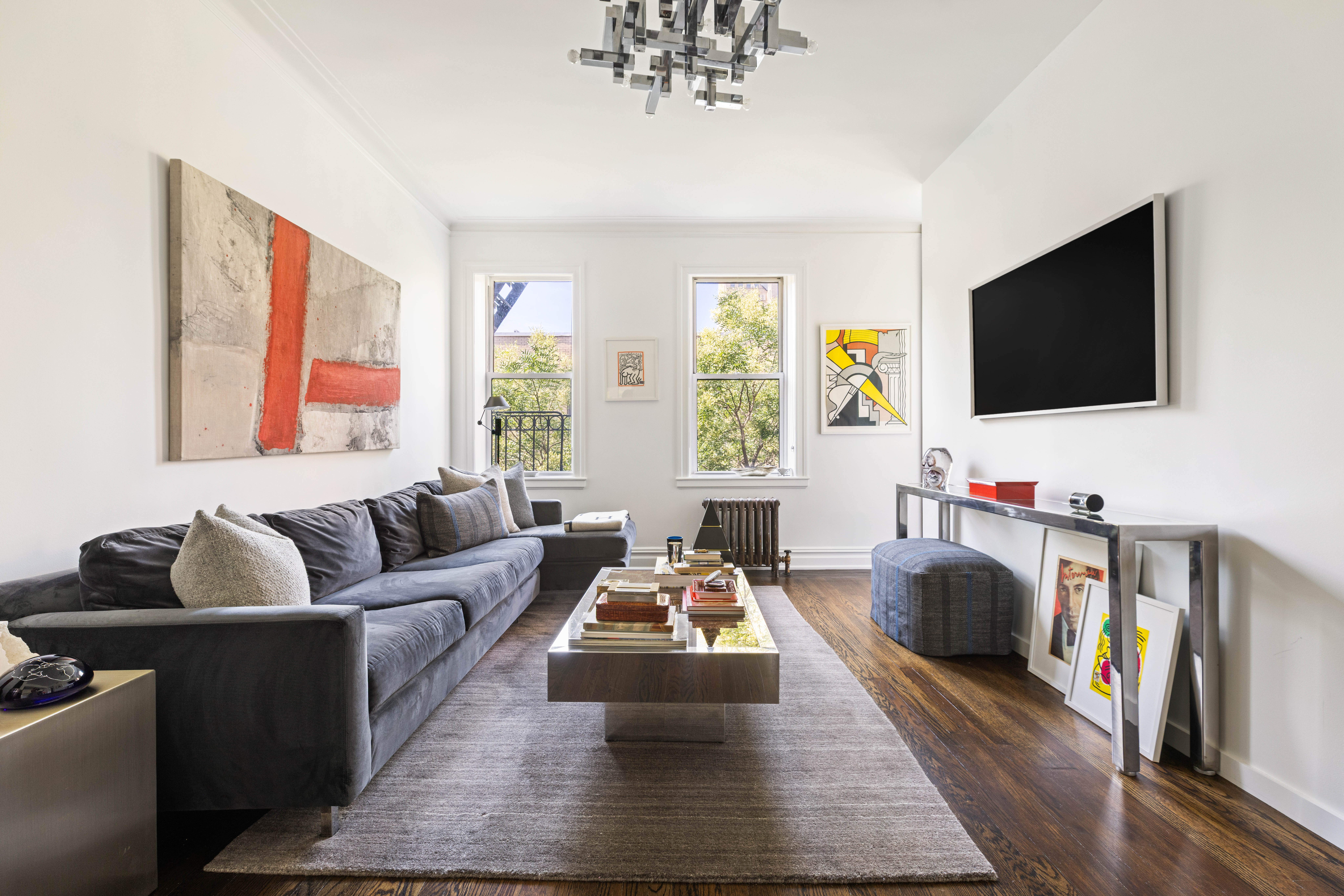 253 West 16th Street, Unit 5C Manhattan, NY 10011 - Photo 2 of 11 a living room with furniture and a flat screen tv