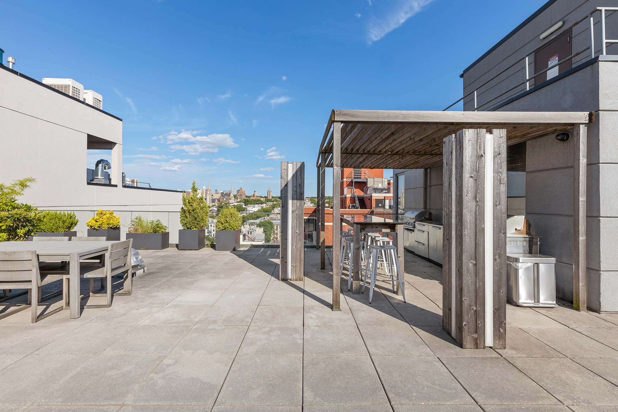 251 1st Street, Unit 7F Brooklyn, NY 11215 - Photo 17 of 24 a view of a patio with table and chairs near a barbeque
