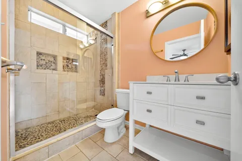 a bathroom with a sink a toilet and a mirror
