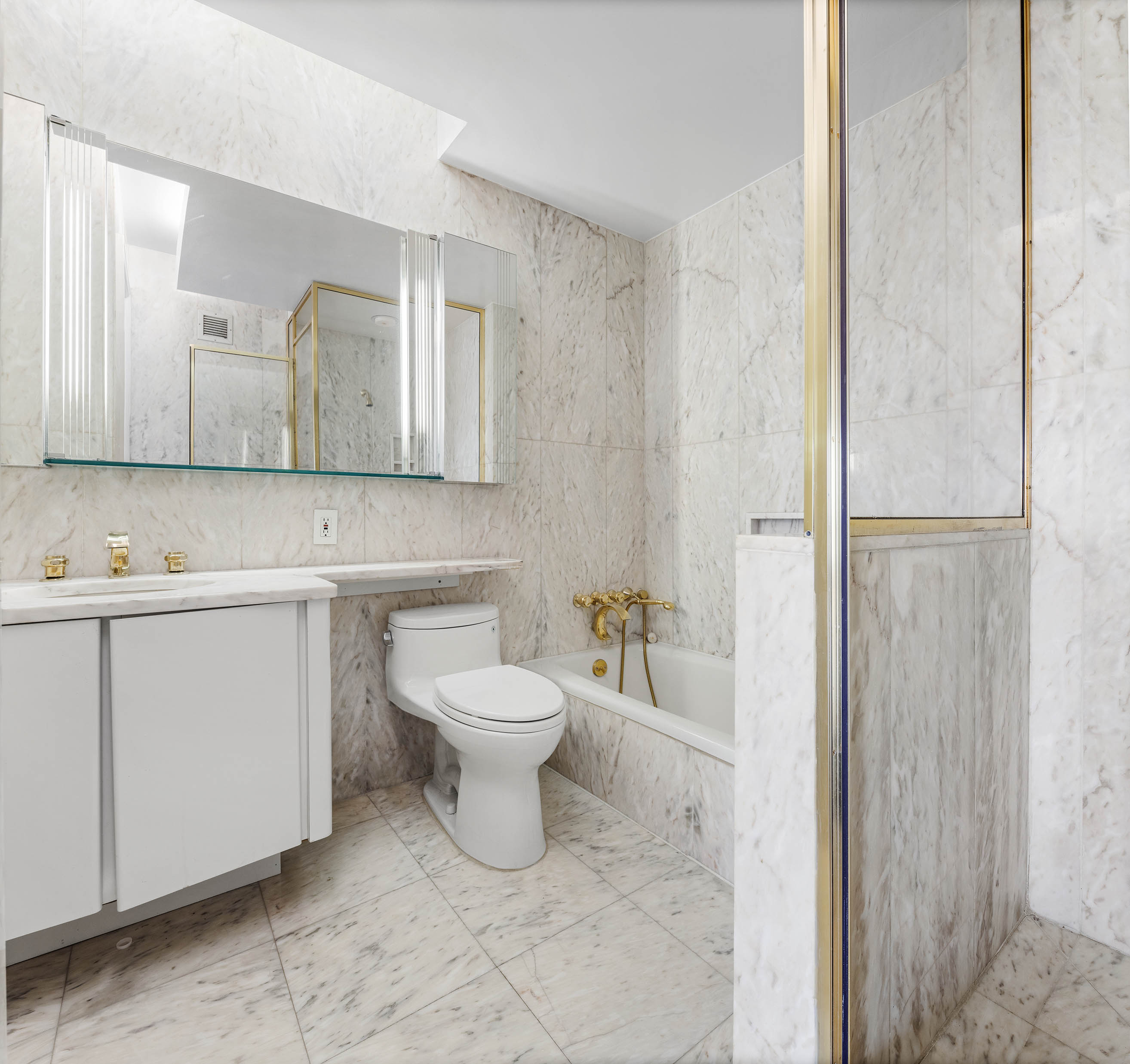 530 East 76th Street, Unit PH36/37E Manhattan, NY 10021 - Photo 10 of 29 a bathroom with a toilet sink and mirror