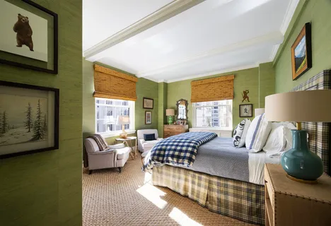 a bedroom with furniture and a large window