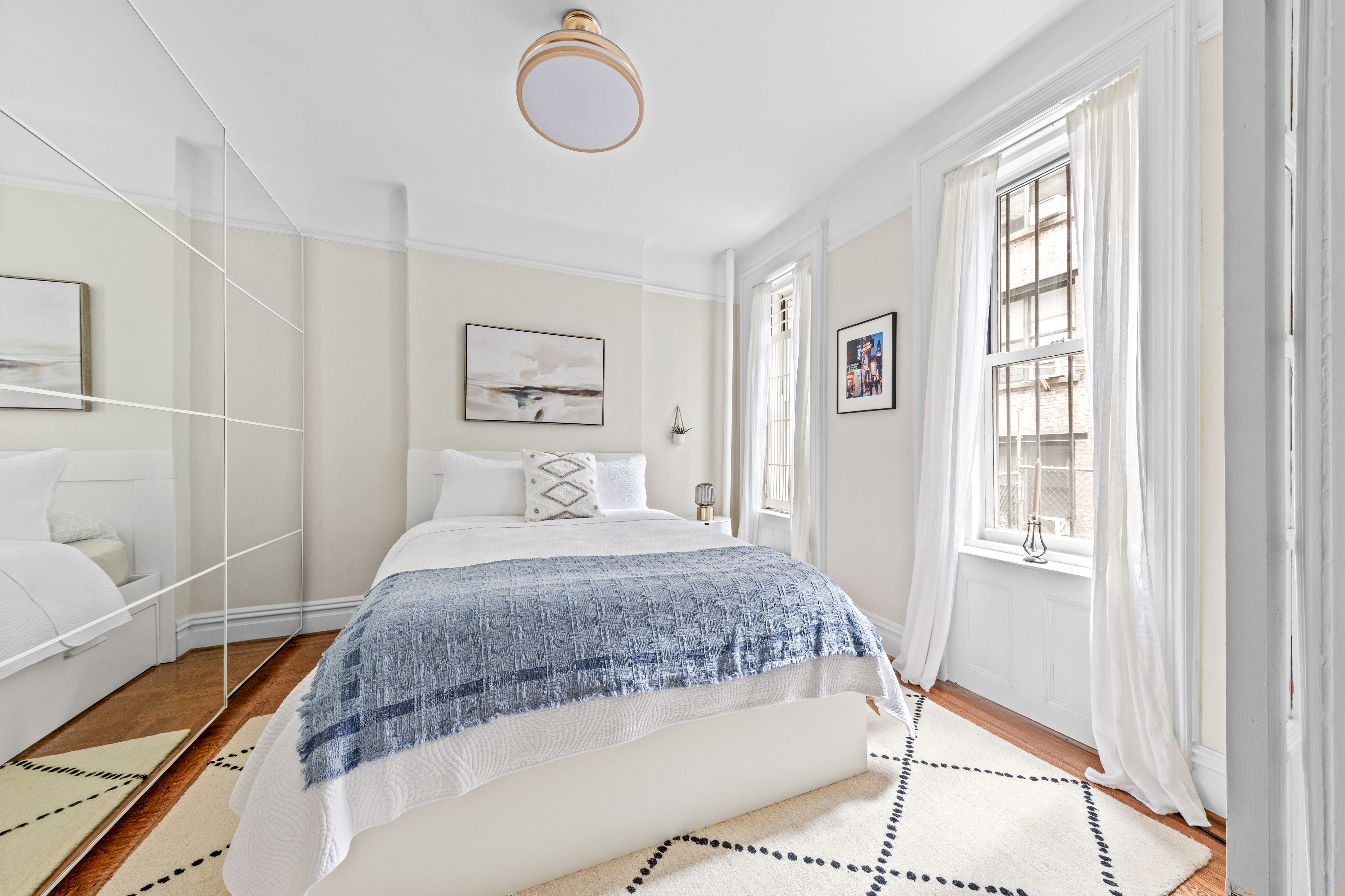 317 West 93rd Street, Unit 1C Manhattan, NY 10025 - Photo 5 of 9 a bedroom with a bed and wooden floor