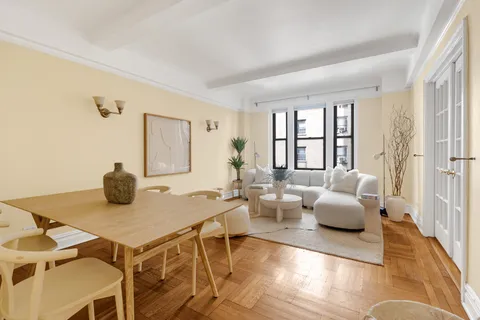 a dining room with furniture and wooden floor