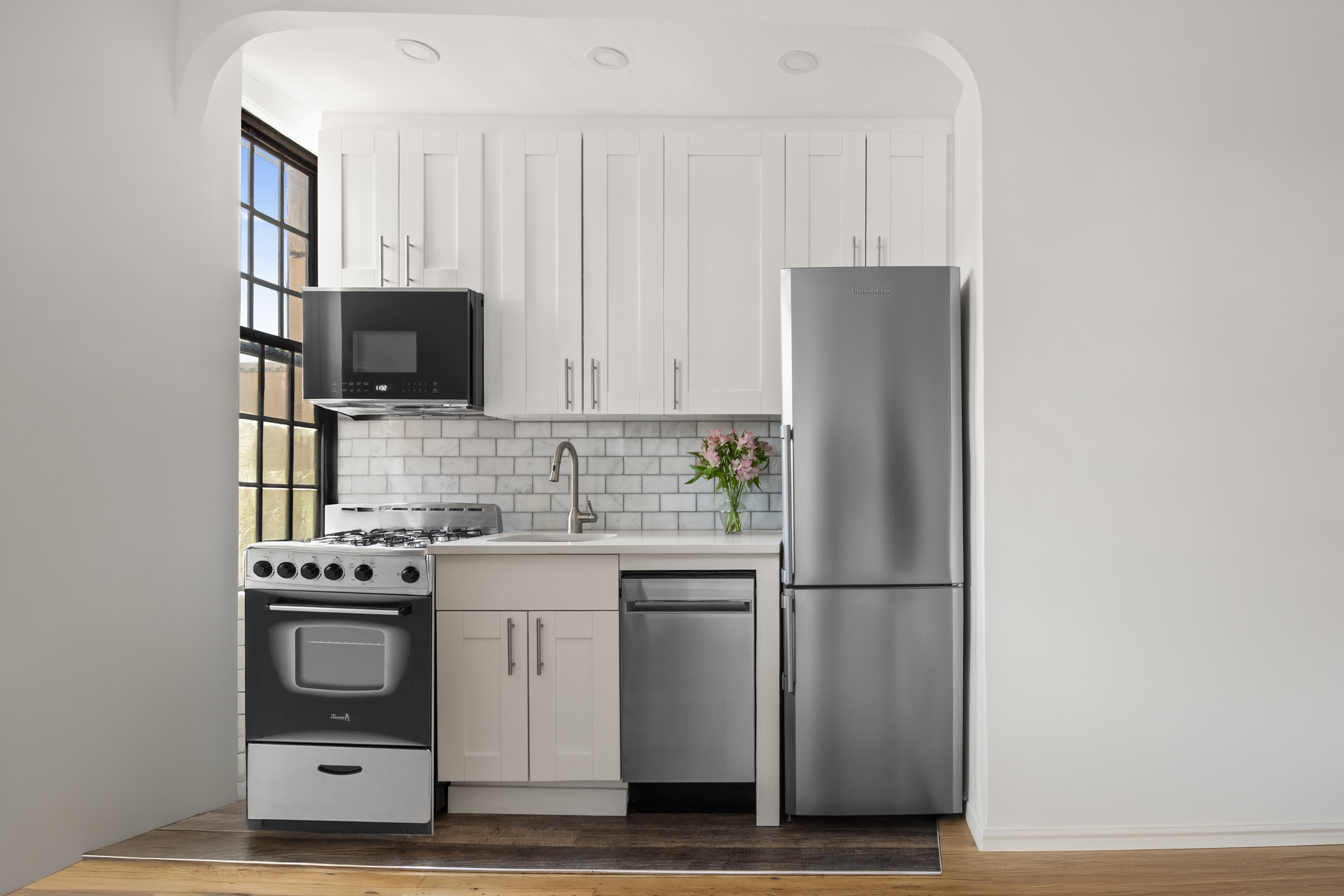 78 8th Avenue, Unit 6F Brooklyn, NY 11215 - Photo 2 of 8 a kitchen with stainless steel appliances a refrigerator stove and microwave
