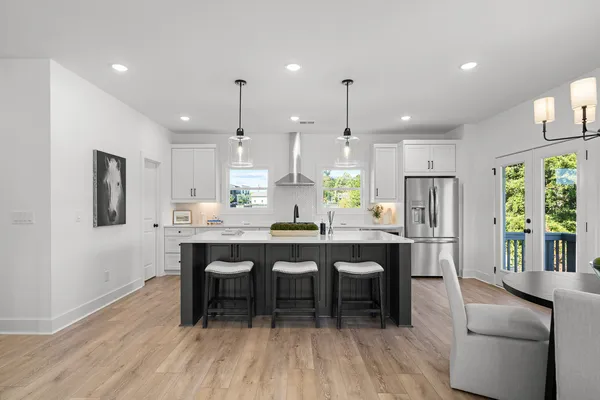 a large kitchen with a table and chairs