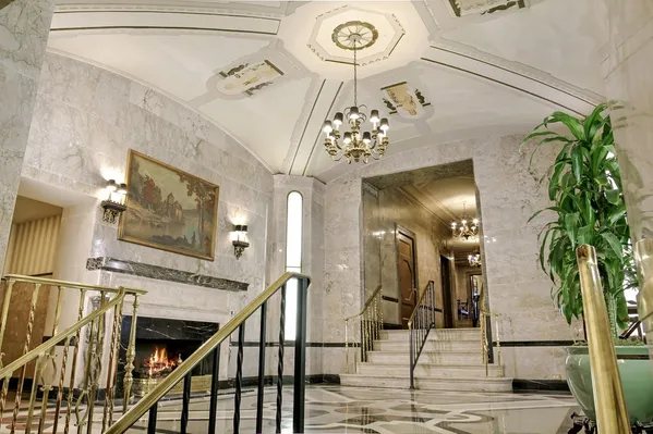 a view of a hallway with chandelier