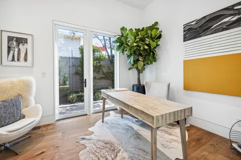 a living room with furniture and a potted plant