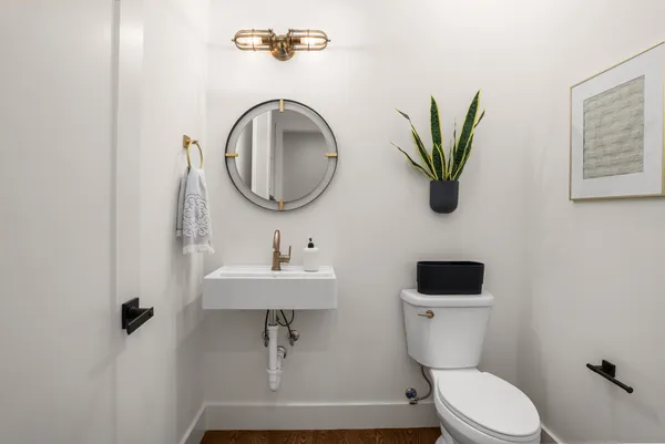 a bathroom with a toilet a sink and a mirror