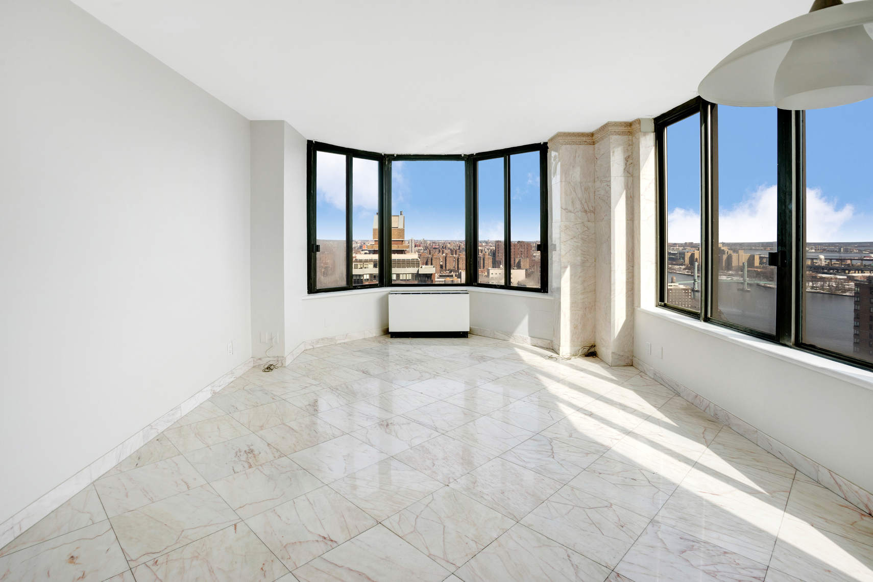 300 East 93rd Street, Unit 35D Manhattan, NY 10128 - Photo 4 of 13 a view of an empty room with large windows