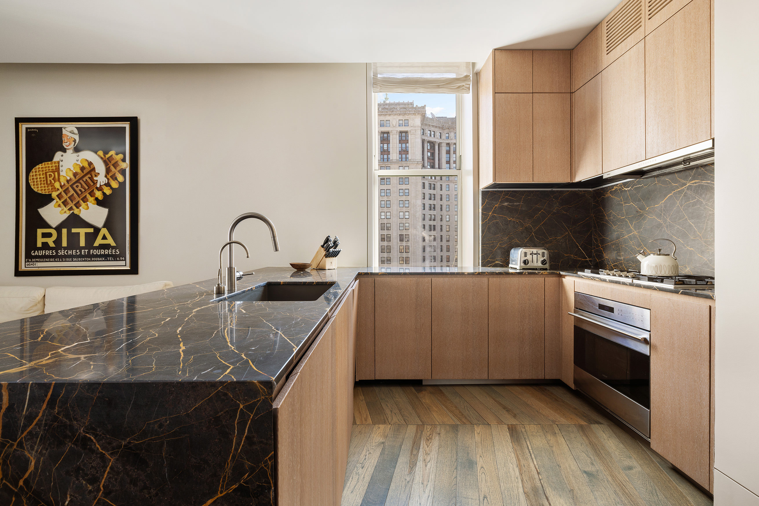 49 Chambers Street, Unit 17H Manhattan, NY 10007 - Photo 5 of 25 a kitchen with a stove and a sink