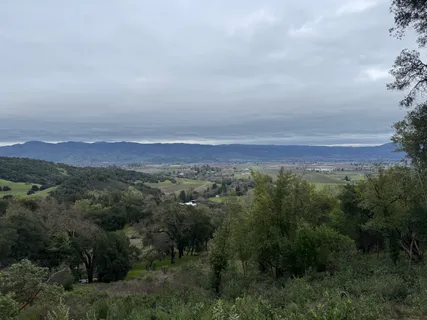an aerial view of a city and mountain view in back