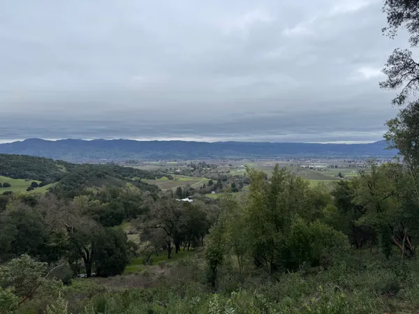 an aerial view of a city and mountain view in back