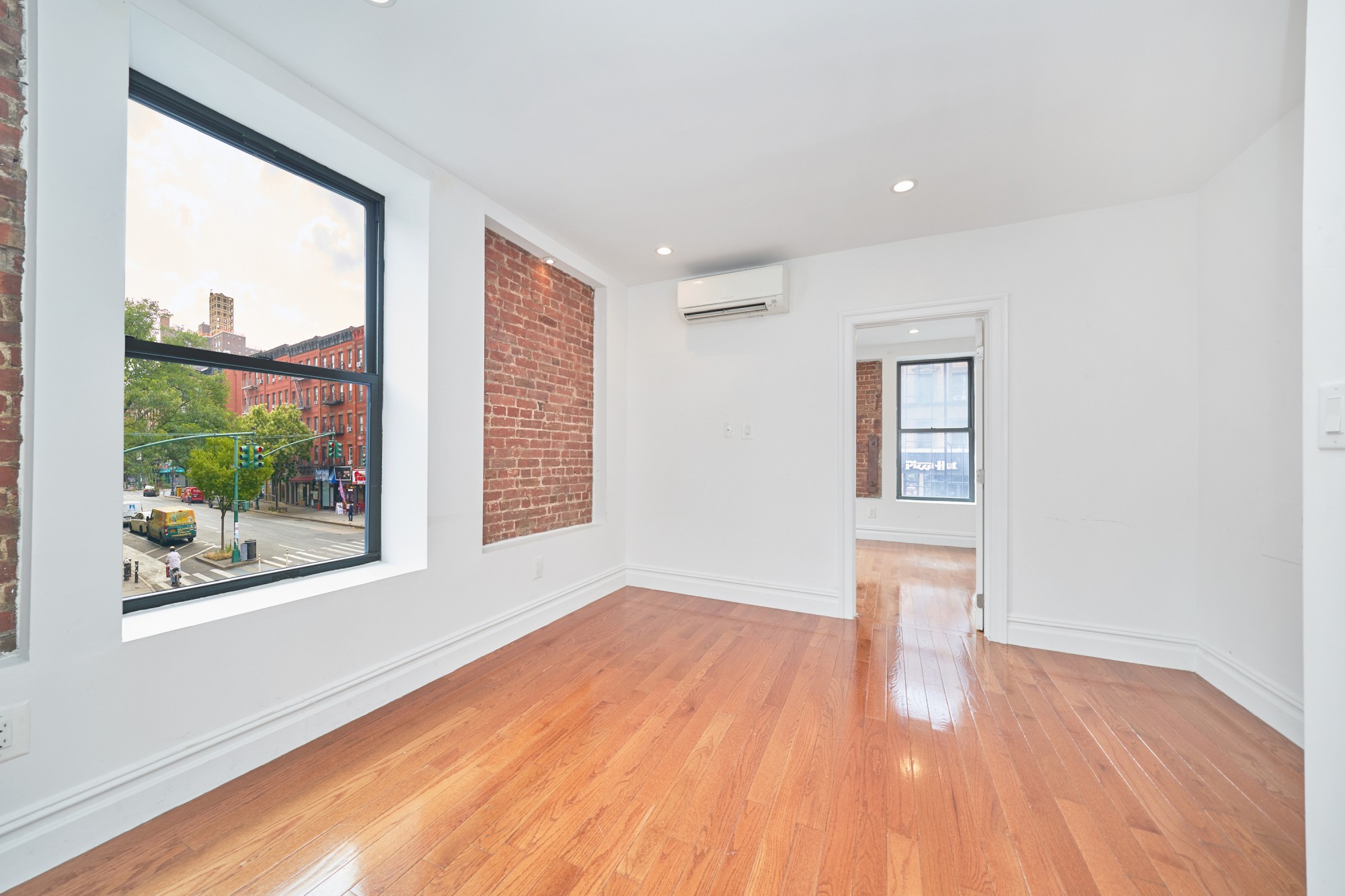941 Columbus Avenue, Unit 1A Manhattan, NY 10025 - Photo 9 of 14 a view of empty room with wooden floor and fan