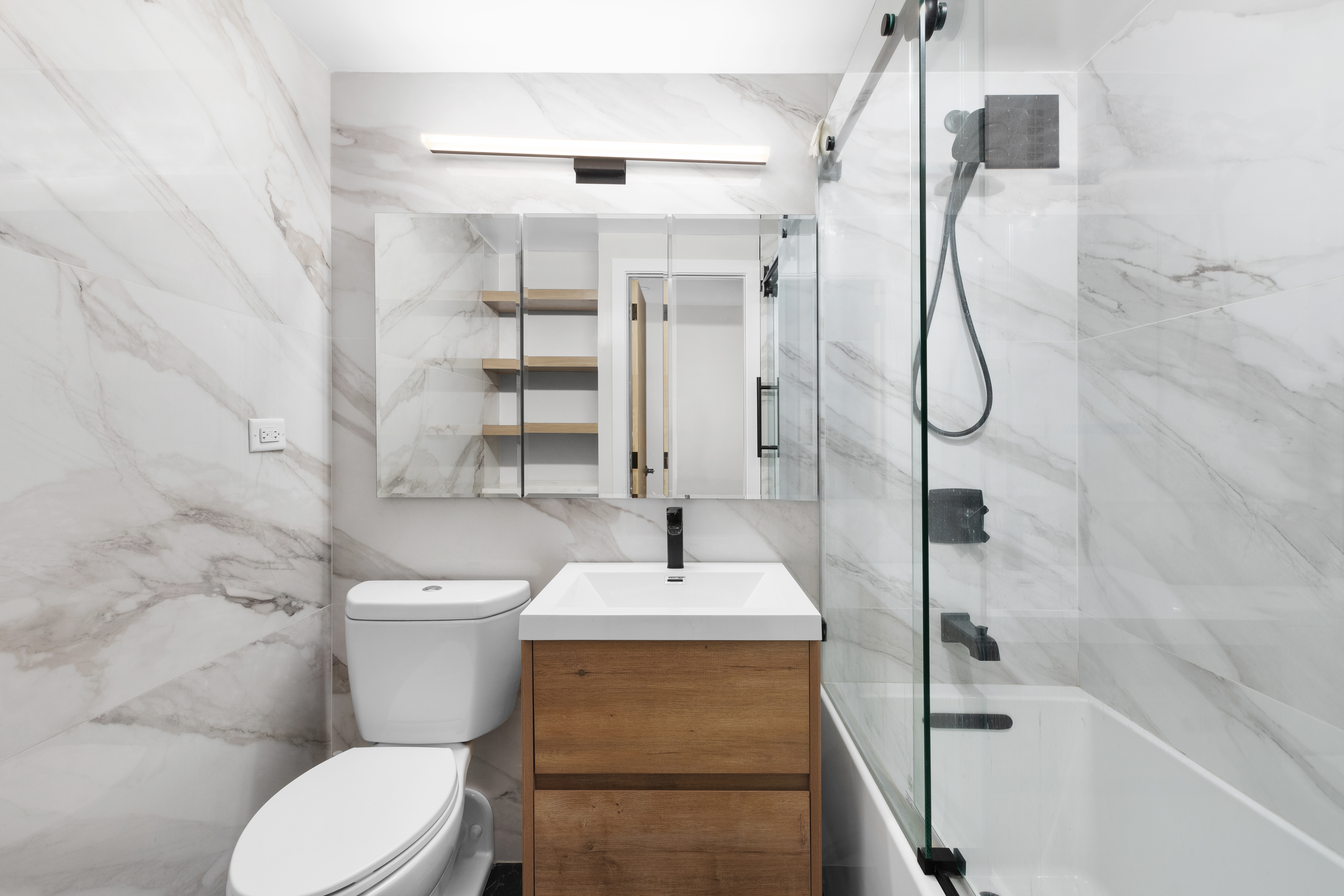 350 East 62nd Street, Unit 4Q Manhattan, NY 10065 - Photo 5 of 6 a bathroom with a sink a toilet and shower