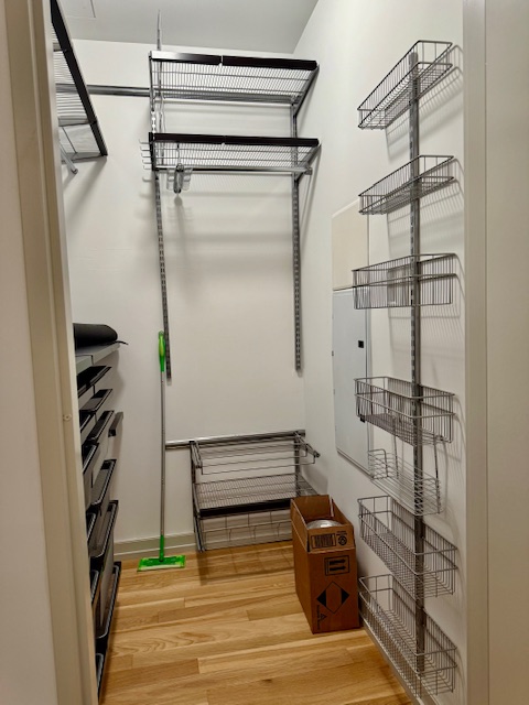 21-45 44th Drive, Unit 1H Queens, NY 11101 - Photo 5 of 7 a view of walk in closet with clothes and shoes