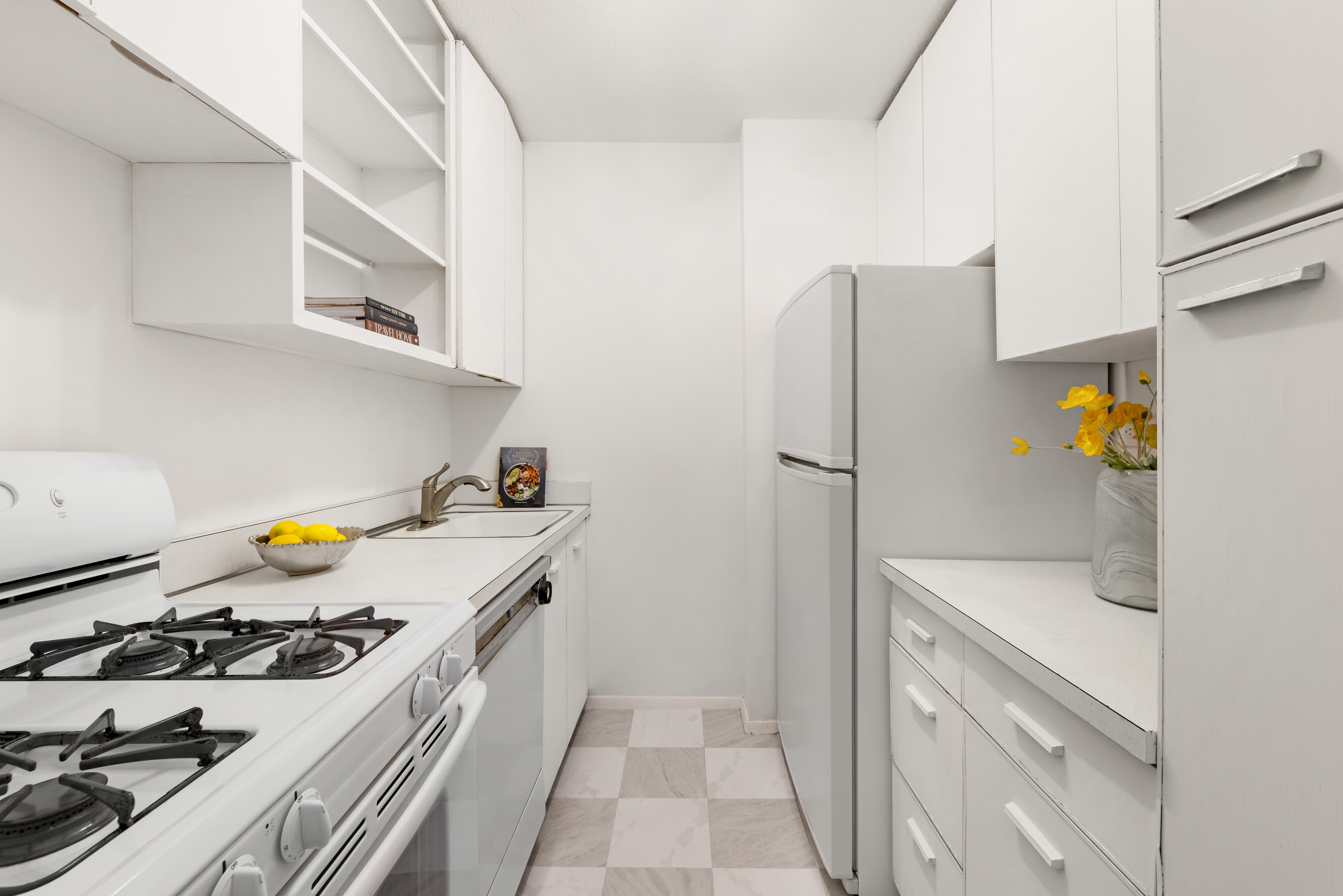 250 East 87th Street, Unit 6E Manhattan, NY 10128 - Photo 4 of 12 a kitchen with stainless steel appliances a stove a refrigerator and cabinets