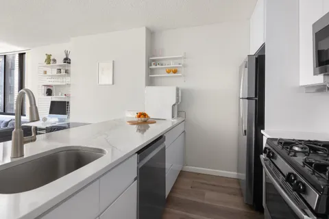 a kitchen with a sink and a stove top oven