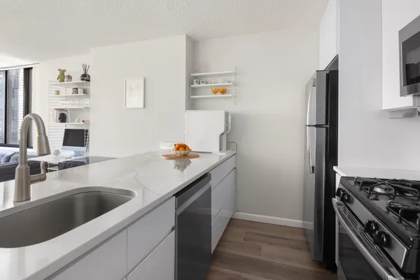 a kitchen with a sink and a stove top oven