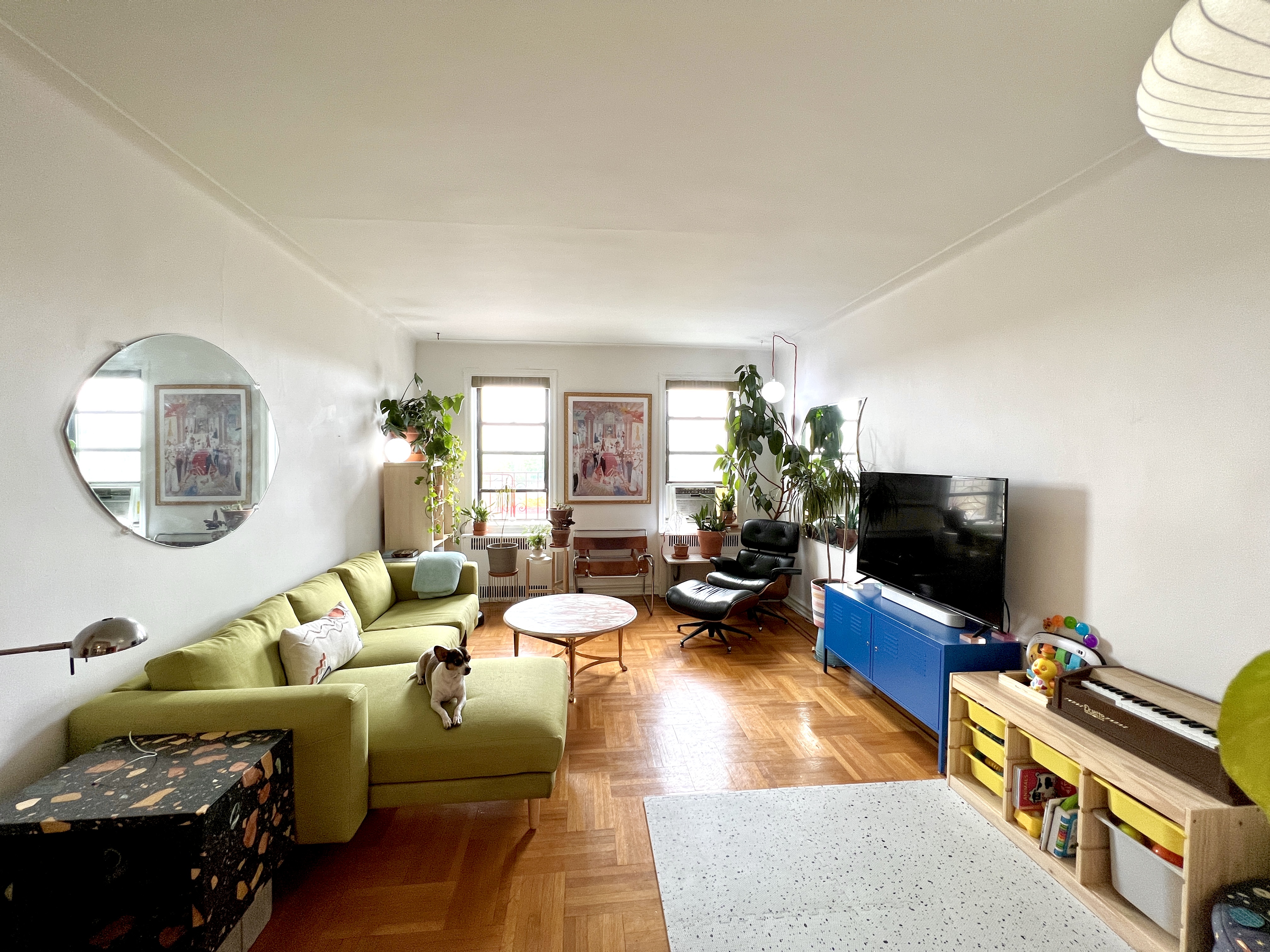 909 East 29th Street, Unit 6F Brooklyn, NY 11210 - Photo 2 of 12 a living room with furniture and a flat screen tv