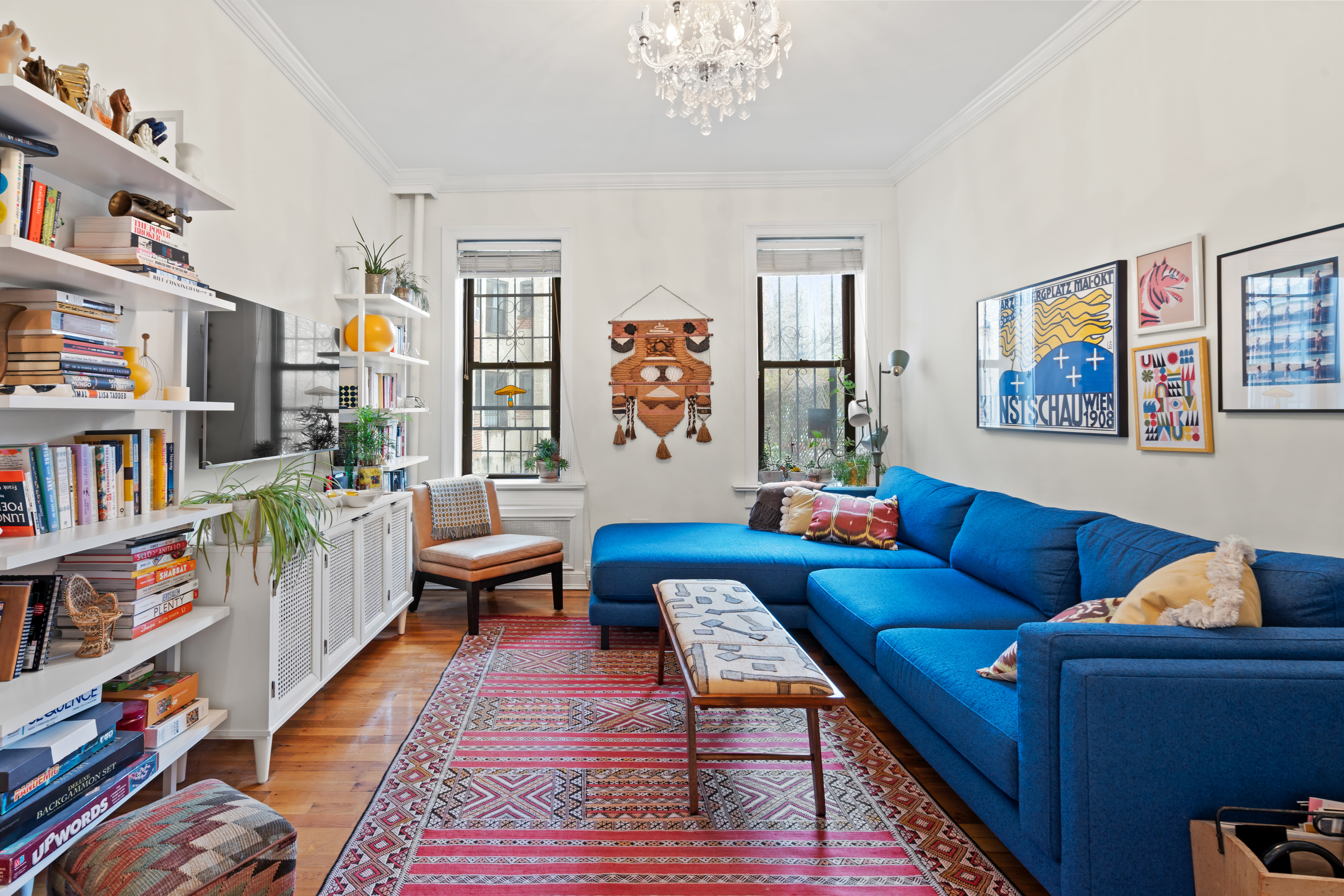 a living room with furniture and a book shelf