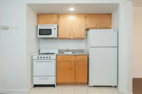 a kitchen with stainless steel appliances a refrigerator sink and stove