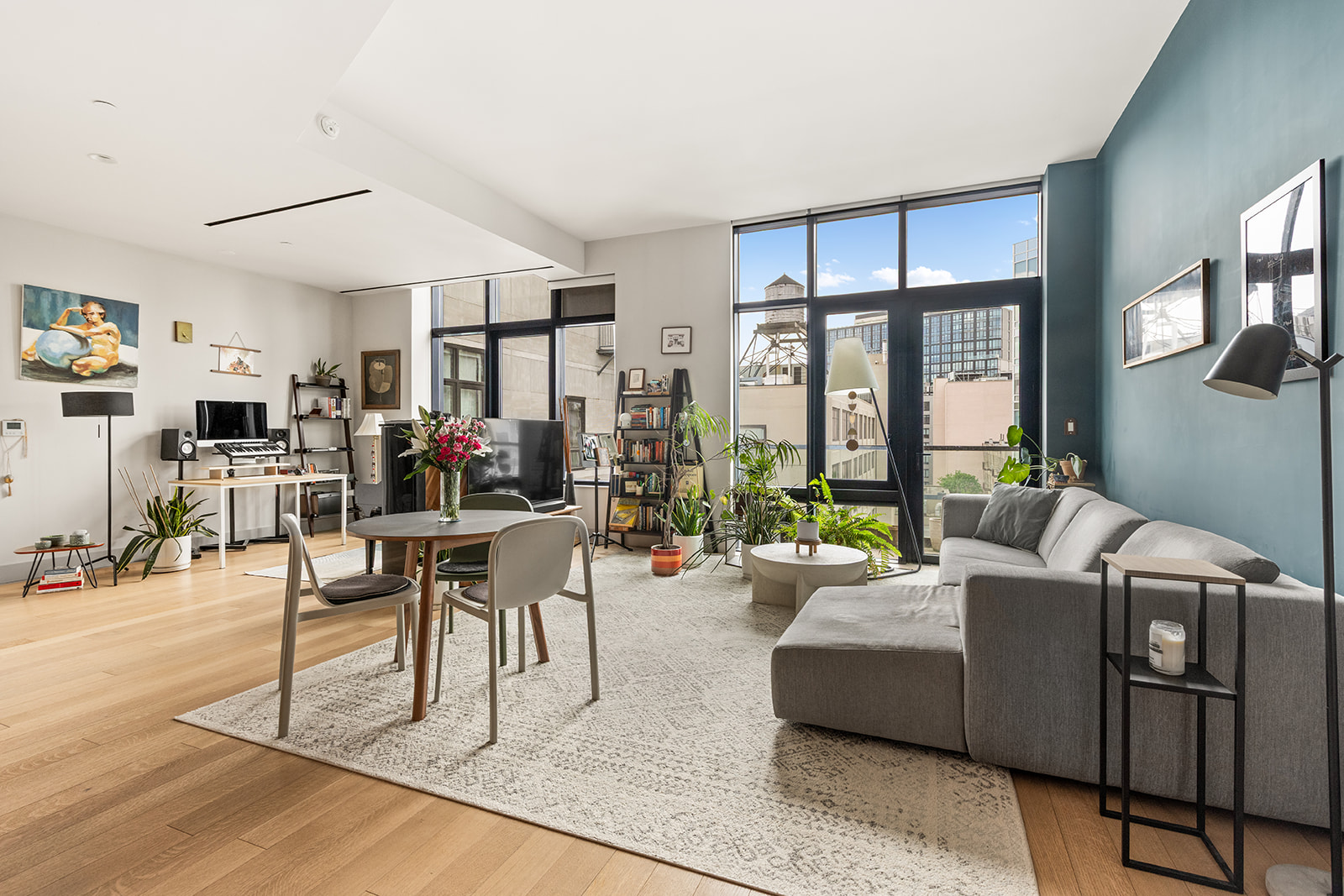 500 Waverly Avenue Brooklyn, NY 11238 - Photo 2 of 13 a living room with furniture a flat screen tv and a floor to ceiling window