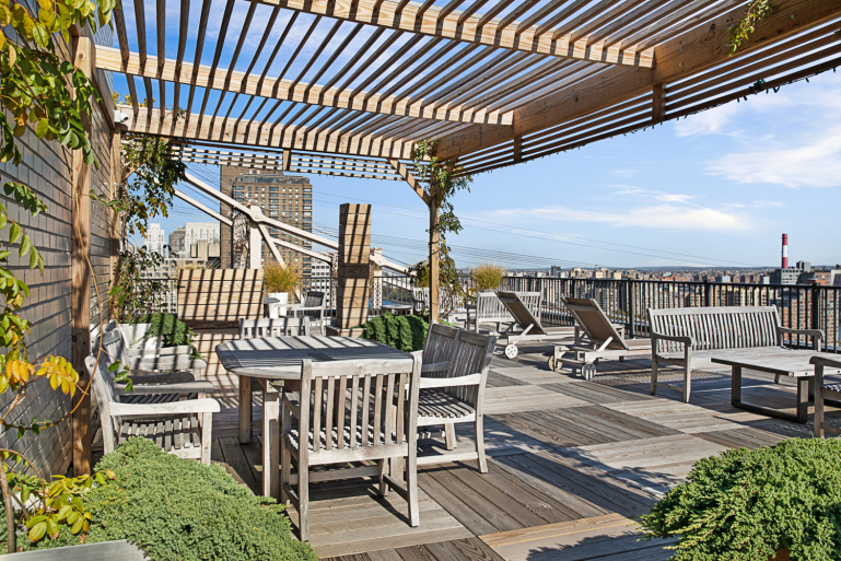 35 Sutton Place, Unit PHB Manhattan, NY 10022 - Photo 11 of 14 an outdoor sitting area with a table