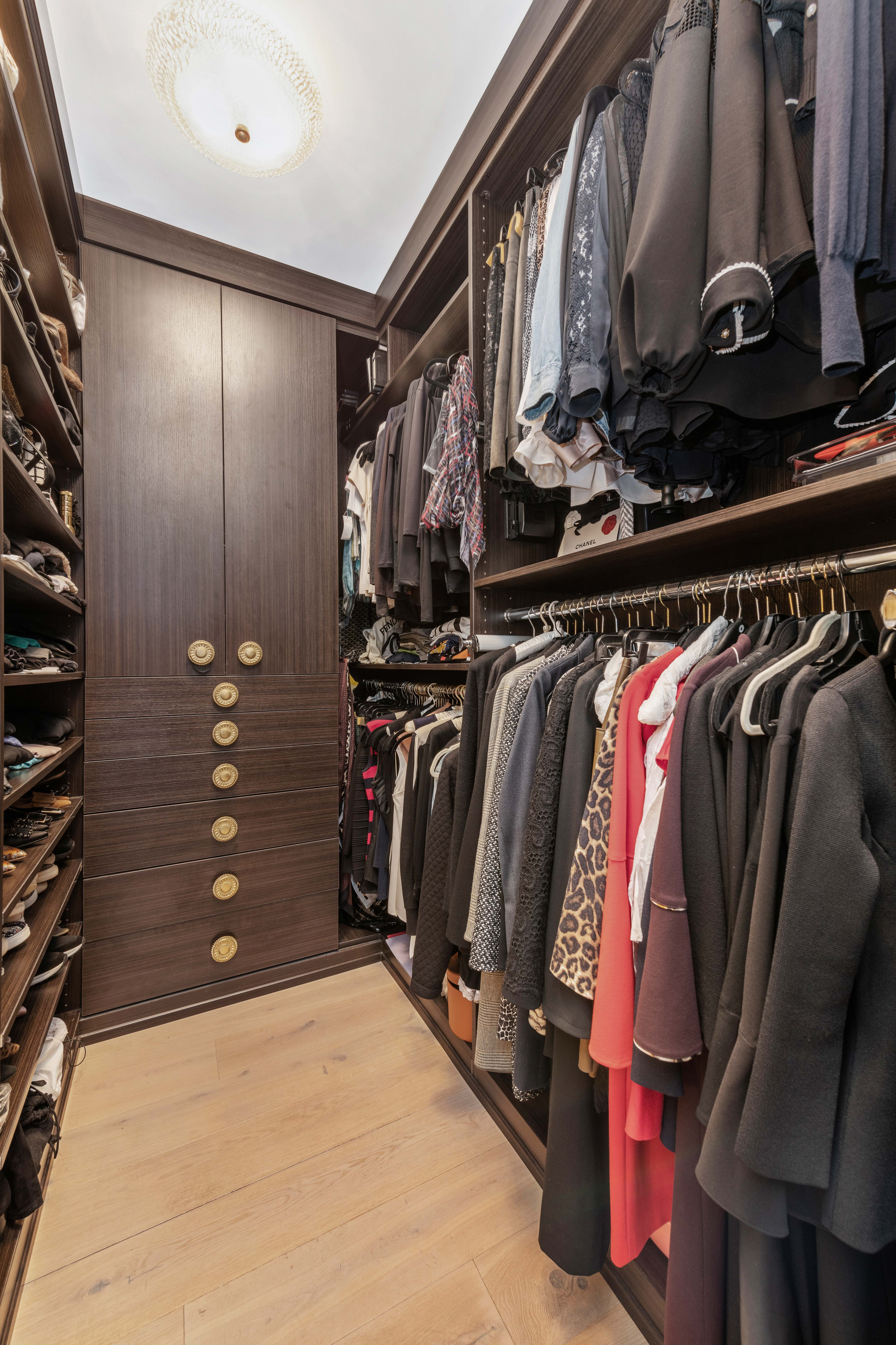 200 East 62nd Street, Unit 5A Manhattan, NY 10065 - Photo 16 of 25 a view of walk in closet with clothes and shoes